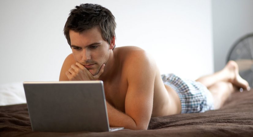 Man in Bed with Laptop Photo