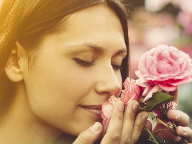 Woman Smelling Pink Roses