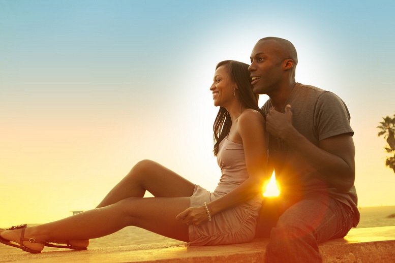 sunset holidaying couple with odeco kegel balls