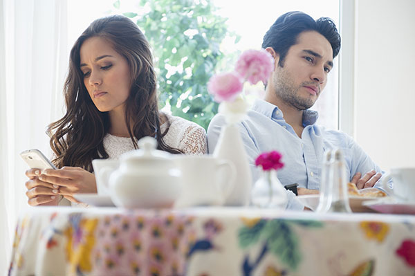 Two People Sitting Looking Away From Each Other