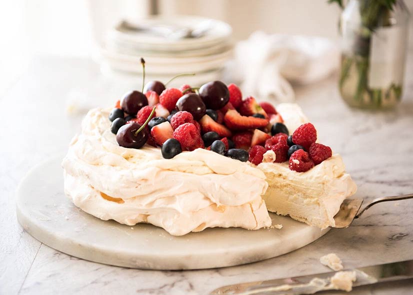 A pavlova cake with fruit