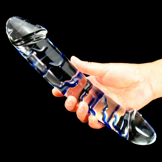 a woman holding a glass dildo 