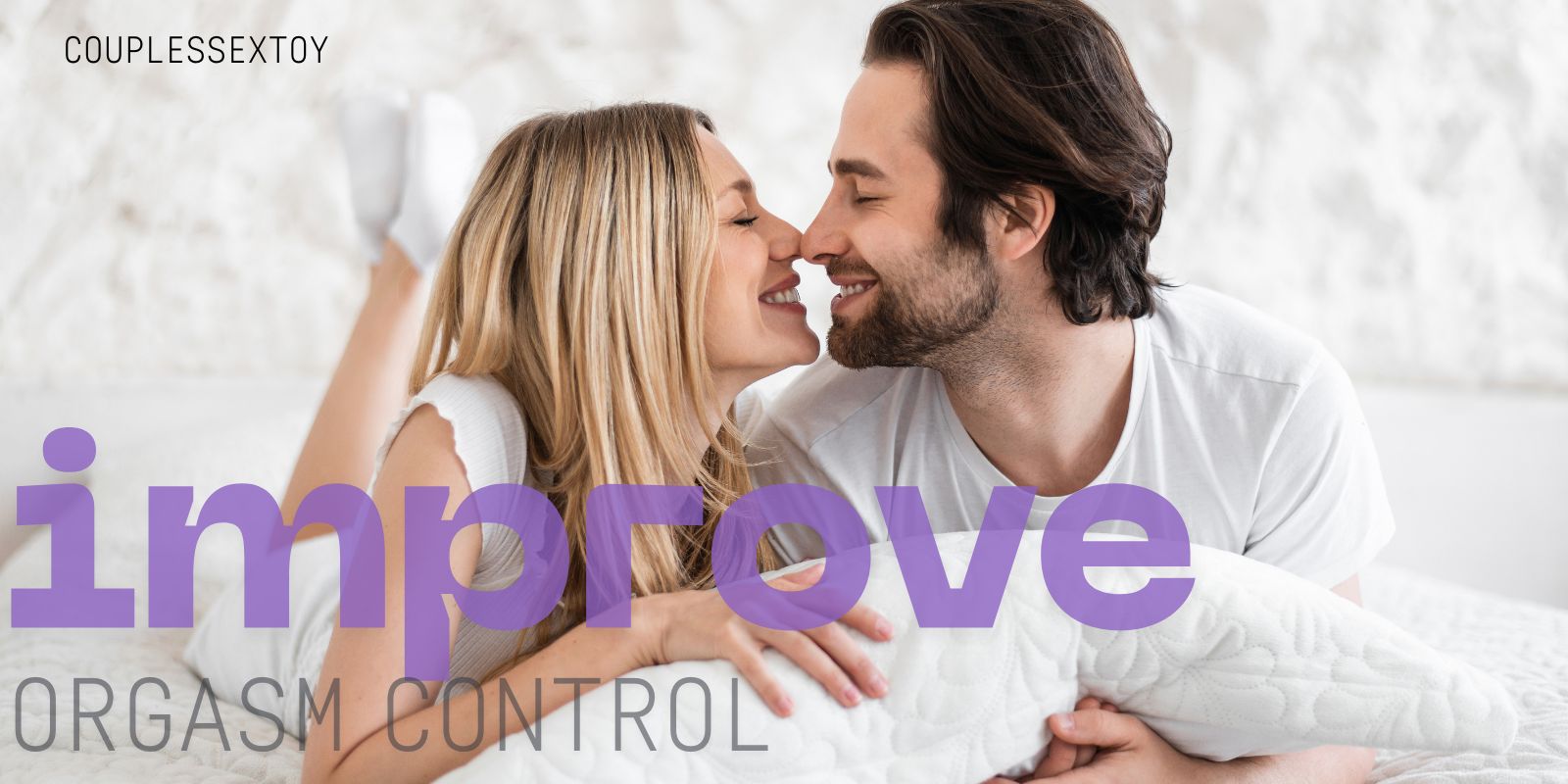 Happy couple lying on a bed, smiling and touching noses while embracing a white pillow